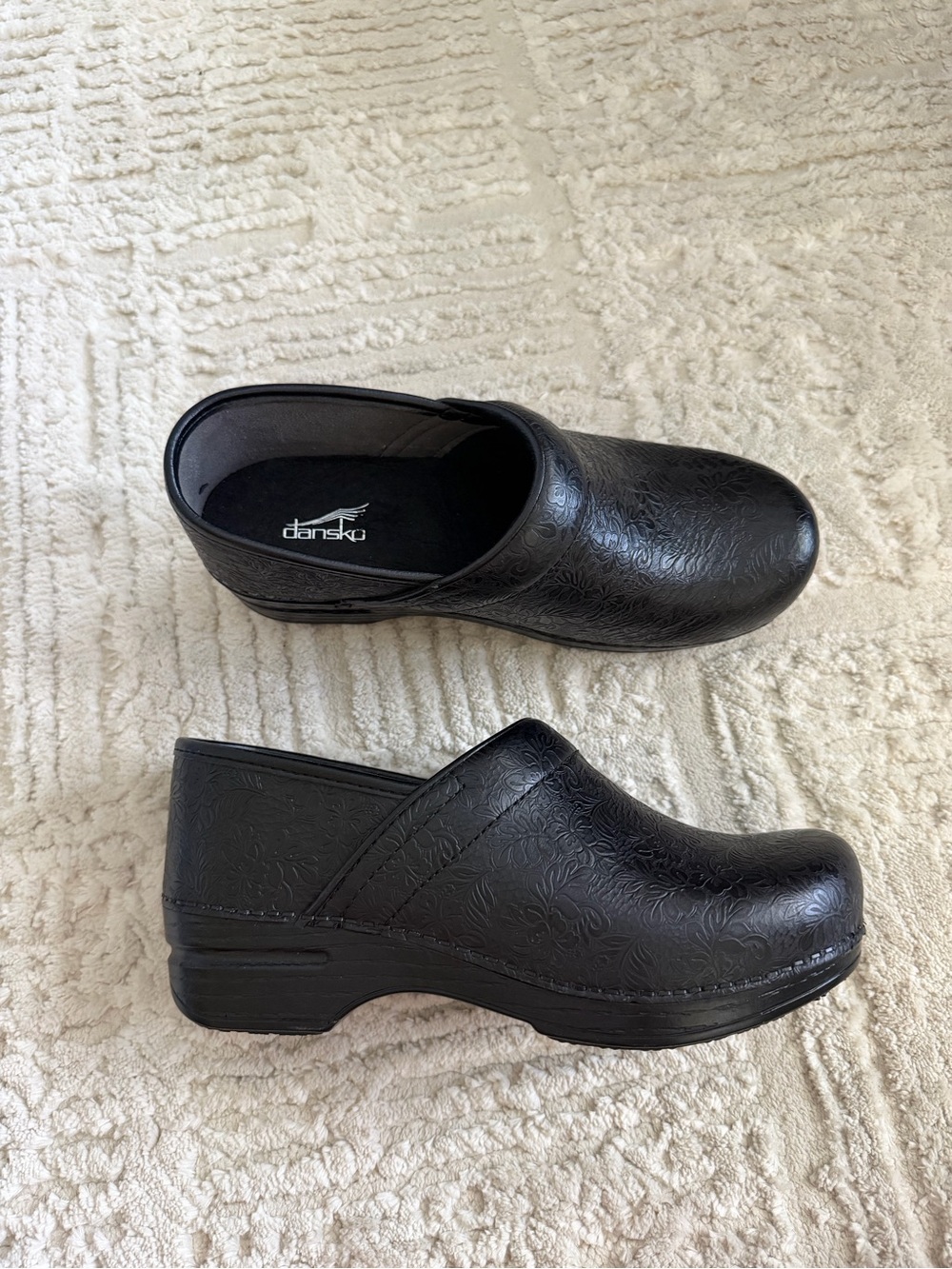 Dansko Black Floral Embossed Clogs